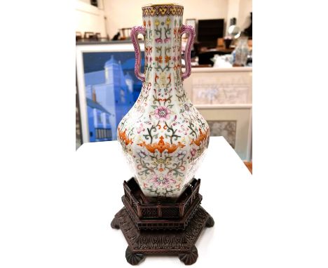 A Chinese porcelain vase of hexagonal baluster form with loop handles, polychrome stylised floral decoration, square seal mar