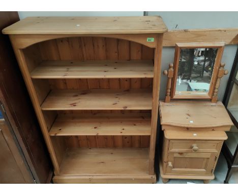 A pine 4 height bookcase; a pine bedside cabinet; a dressing table mirror 