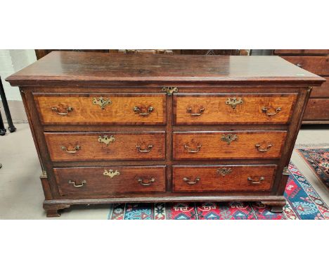 An 18th/19th century oak crossbanded Lancashire chest with four drawers, two top false drawers, carved column with brass fitt