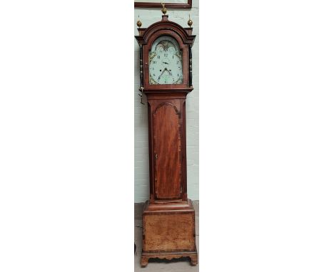 An early 19th century mahogany longcase clock with crossbanded decoration, the hood with brass finials and brass mounted turn