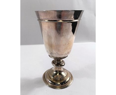 An 18th century silver chalice of plain form with knopped stem and shallow domed foot, the conical bowl with raised shoulder 
