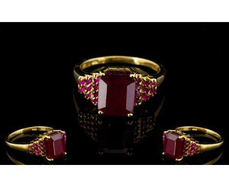 Ruby Octagon Solitaire Ring with stepped ruby shoulders; the solitaire, a rich red ruby measuring a generous 5.5cts, flanked 