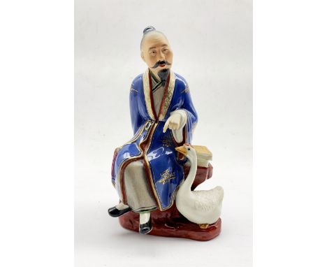 20th century Chinese ceramic group depicting a seated Scholar, a goose at his feet, impressed and printed marks beneath, H22c