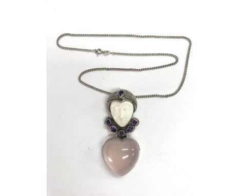 An Art Deco silver, amethyst and rose quartz pendant in the form of a lady's face.