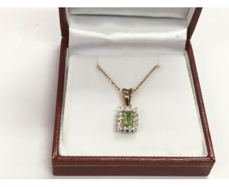 A boxed 9ct rose gold necklace set with a step cut rectangular peridot framed by round cut diamonds, peridot approx 0.42ct, d