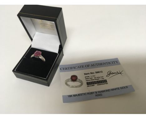 An 18carat gold ring set with a majestic cut ruby approximately 2.17 of a carat flanked by small diamonds with certificate ri