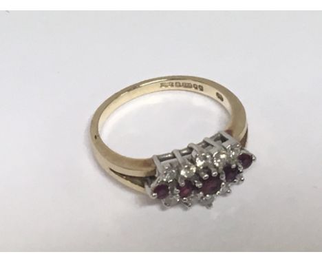 A 9carat gold ring set with a pattern of ruby and diamonds ring size K-L