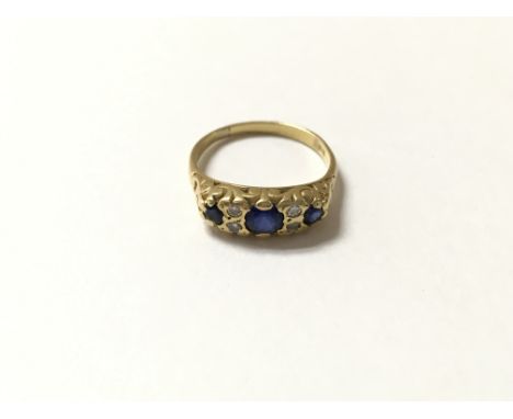 A gold diamond and blue stone ring. Size O and 4.2g approx.