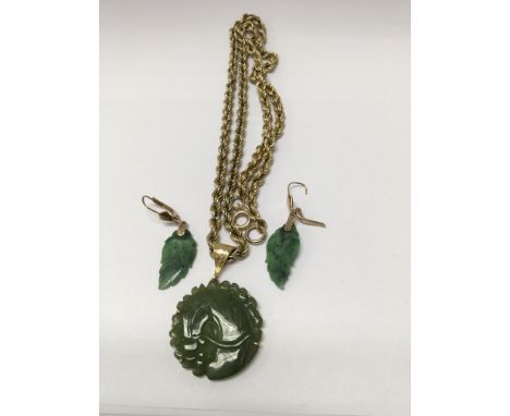 A jade pendant with attached chain together with a pair of leaf design earrings.