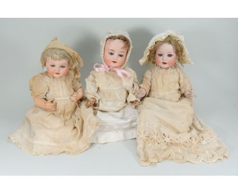 Three bisque head baby dolls, German circa 1915, including an A.M 990 with weighted blue glass eyes, open mouth, two upper te