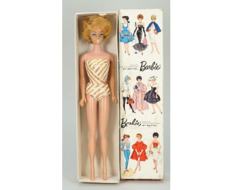 A boxed vintage Mattel Bubble Cut Barbie Platinum doll, with painted blue eyes and light blue lips, wearing gold and white sw