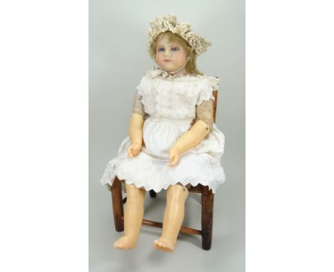 Large poured wax shoulder head doll, circa 1860, with inserted blue glass eyes, painted brows and slightly smiling mouth, ins