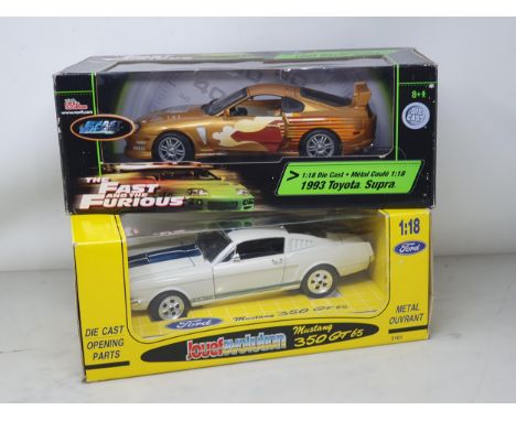 A boxed Racing Champions 1:18 scale Toyota Supra and a boxed Jouef Evolution Ford Mustang 