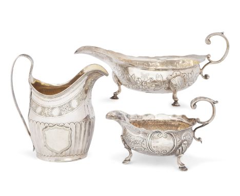 A George III silver cream jug. Peter, Ann & William Bateman, London, 1802. With scrolling handle, decorated with floral motif