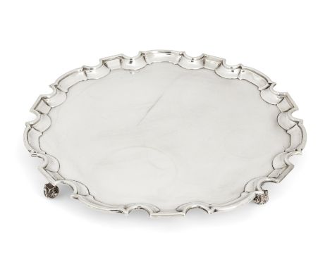 A George V silver salver with Chippendale border. William Hutton & Sons, Sheffield, 1930. Of shaped, circular form, the flat 