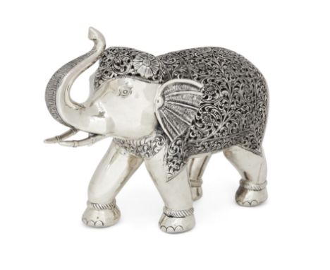 A large model of an Indian elephant. Unmarked. Modelled in walking pose with trunk raised, the head and body pierced and chas