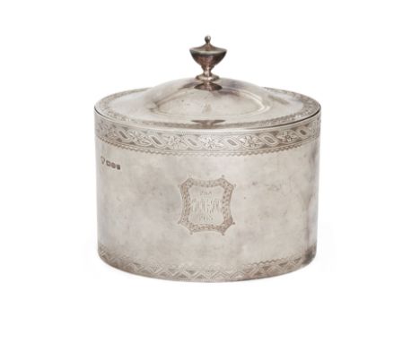 A George VI oval silver tea caddy/biscuit box. Nathan Bloom & Son, London, 1941. Of oval form, the hinged cover with an urn-s