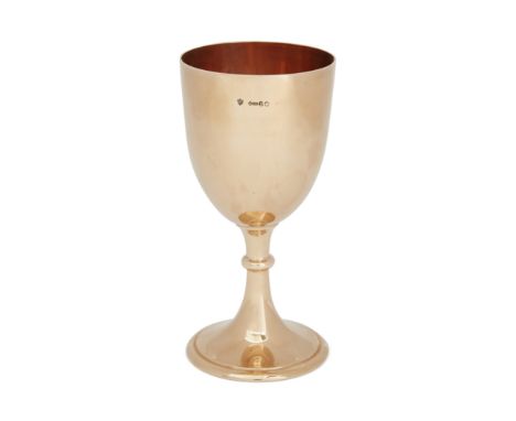 An Edwardian 9ct gold wine goblet. Edward Barnard & Sons, London, 1903. The plain cup raised on a knopped stem to a spreading