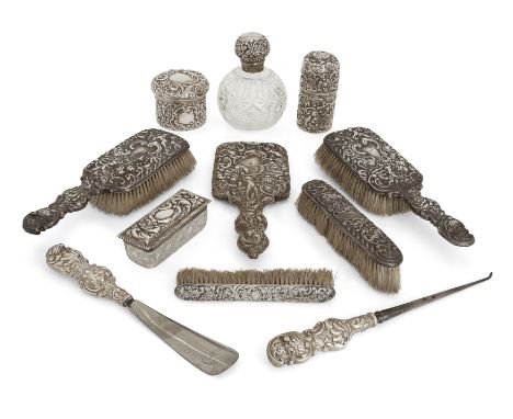 A group of silver and silver mounted vanity vessels and brushes. Various dates and makers. The group comprising: a Victorian 