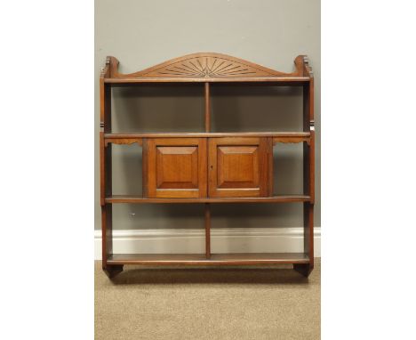 Edwardian walnut wall cupboard, arched cresting above six compartments and two panel doors, W74cm, H85cm, D18cm   Condition R