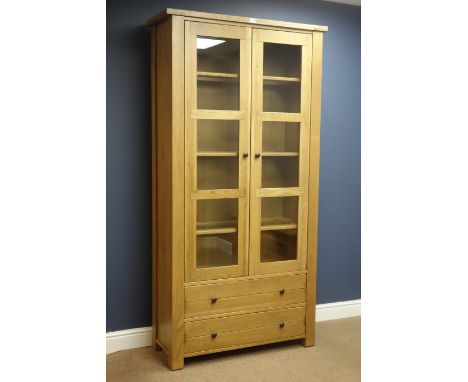 Willis & Gambier solid light oak bookcase display cabinet with glazed panel doors and two base drawers, W102cm, H199cm, D40cm