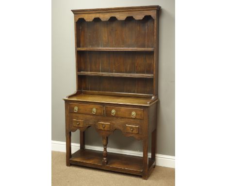 Small 17th century style oak dresser with plate rack, two drawers and three small spice drawers, turned middle support with u