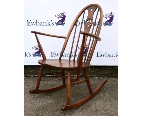 Ercol rocking chair .   Chips to back of the top of frame, as well as some to the arms. Loss of colour to the arms and eviden