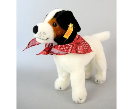 A Steiff toy dog wearing a red scarf, tag number 083730.This lot being sold on behalf of Princess Alice Hospice.   