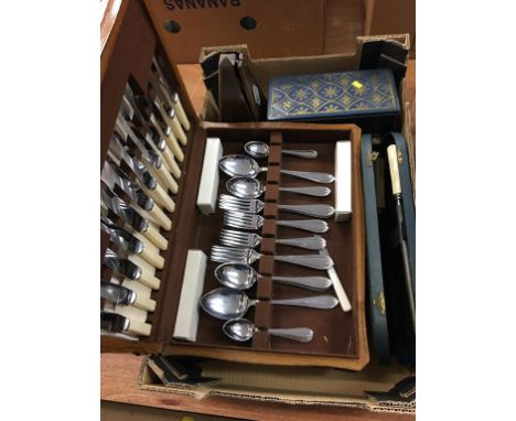 Assorted cutlery and a metronome