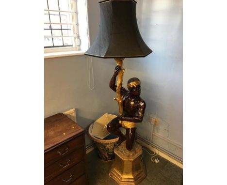 A carved Blackamoor standard lamp