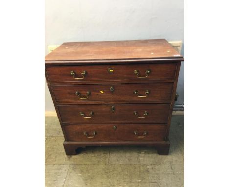 A Georgian mahogany straight front chest of drawers with four long graduating drawers, all with brass handles, supported on b