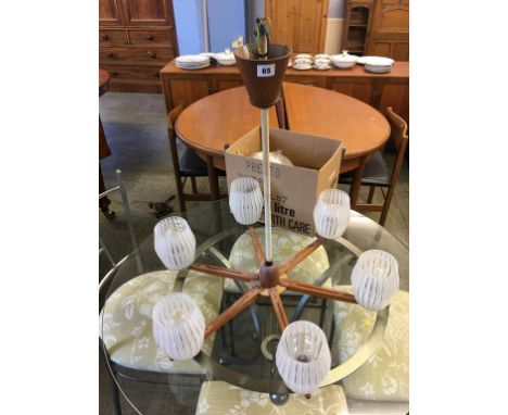 A 1960s glass and teak light fitting and spare shades