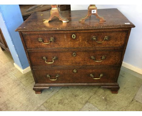 A small Georgian oak chest of drawers, with three long graduating drawers, supported on bracket feet, 83cm wide