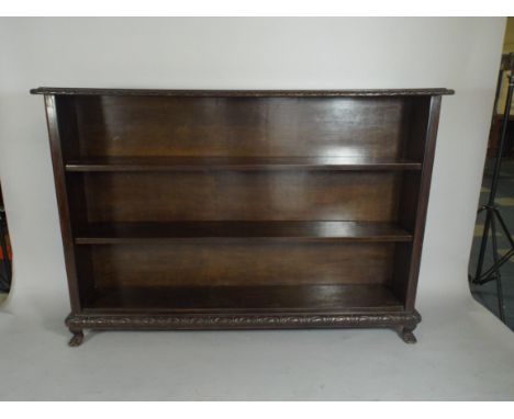An Edwardian Oak Two Shelf Open Bookcase with Carved Top and Bottom Rails. Claw Feet. 174x30x121cm