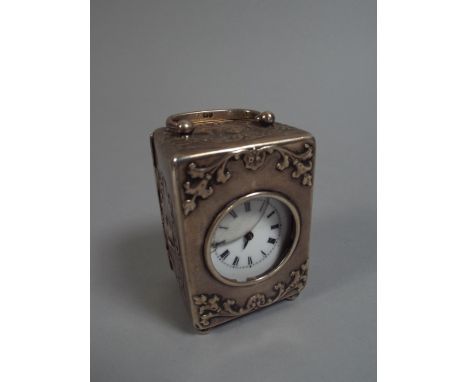 A Silver Cased Carriage Clock, Decorated with Embossed Cherubs and Stylised Wreaths. on Four Bun Feet. Hall Mark for London 1