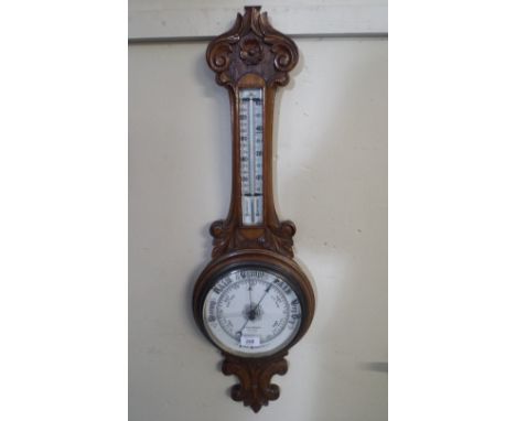 A Late Victorian Carved Oak Aneroid Wheel Barometer by Lennie & Thomson, Dundee.
