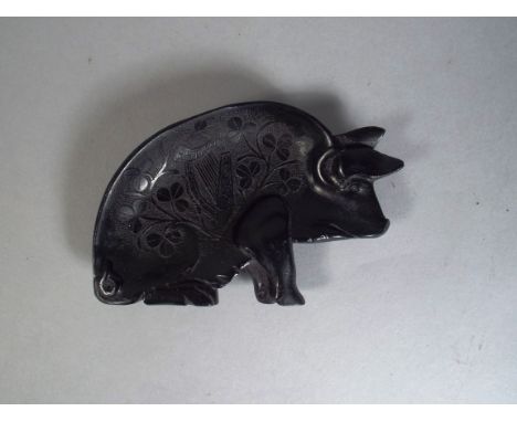 A 19th Century Irish Bog Oak Pin Tray in the Shape of a Pig. Carved with Shamrock and Harp Detail. 11x7cm