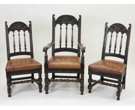 A late 19th century / early 20th century set of eight oak dining chairs in the 17th century style, each with an arched top ra