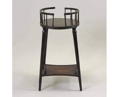 A Regency style mahogany plate stand, the circular galleried top on four slender tapering reeded supports united by a shelf s