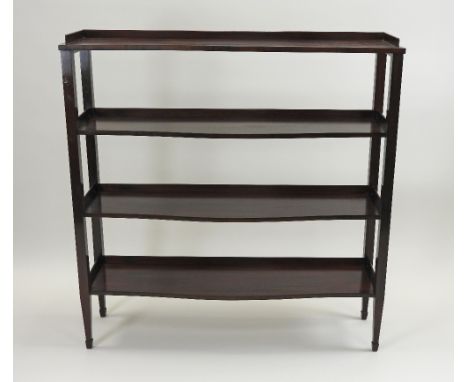 A rosewood four tier serpentine side shelf, in the 18th century style, the three quarter galleried shelves on plain square su