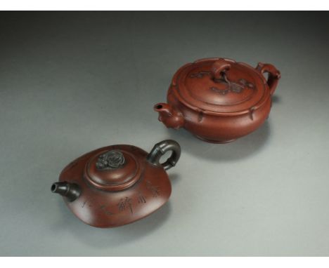 Two Chinese Yixing teapots, 20th Century, the first of lobed form with prunus branch handle, spout and cover finial, 9cm tall