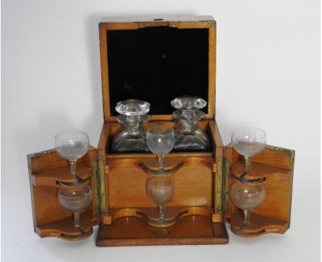 A late Victorian / Edwardian oak fitted decanter box, the hinged lid and front revealing a pair of square decanters and six g