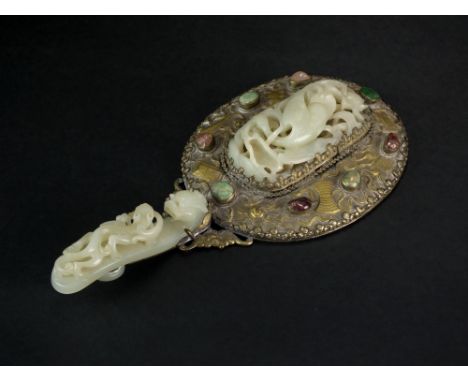 A Chinese jade, hardstone and mixed metal hand mirror, Qing Dynasty, the handle mounted with a pale greenish-white belt hook 