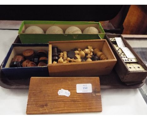 A mid-20thC carved wooden chess set, a set of bone and ebony dominoes, vintage draught pieces, an early set of boxed Dunlop f