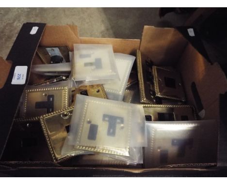 A selection of brass light switches and sockets