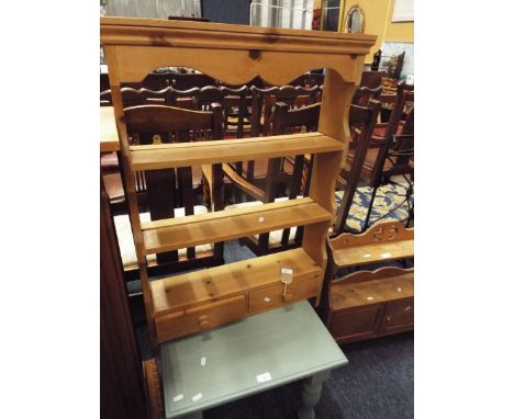 A stripped pine wall shelf with drawers below