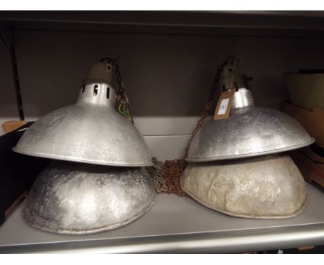 Three vintage industrial aluminium ceiling lights with ceramic fittings and chains, together with one similar for restoration