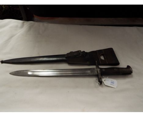 A WWI Swiss bayonet, the blade stamped 'Maschinenfabrik Bern', the crosspiece stamped '64989', complete with steel and leathe