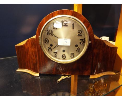 An Art Deco walnut cased mantel clock with silvered dial and Roman numerals