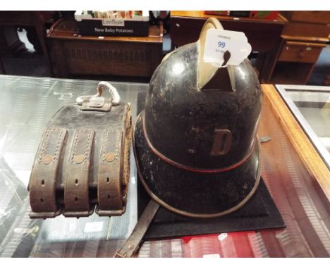 A late 19thC Swiss fire helmet in original paint with brass comb, leather liner and chin guard, together with later belt